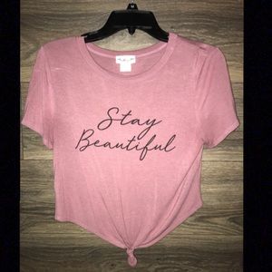 Pink tee shirt with tie at the bottom.